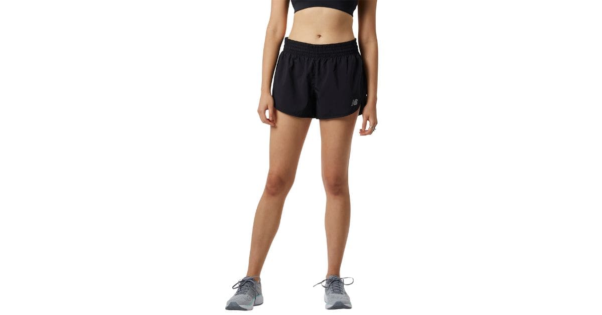 A woman wearing a black sports bra and shorts, showcasing a stylish athletic look suitable for various activities.